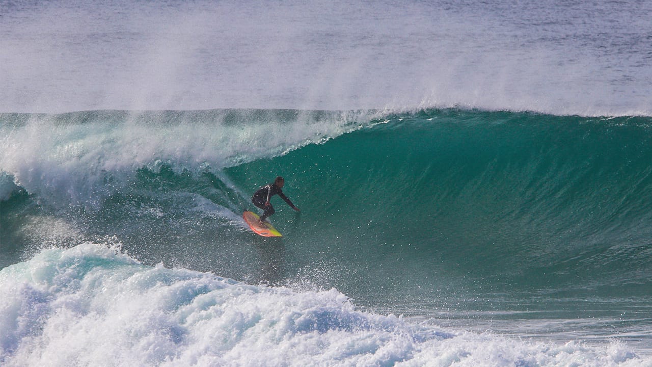 Alex Unwin surfing waves in winter