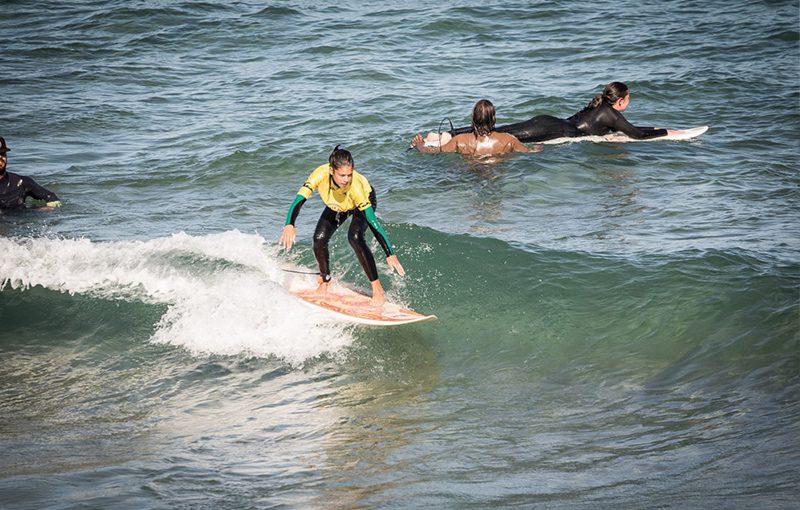 girl surfing guincho beach fun
